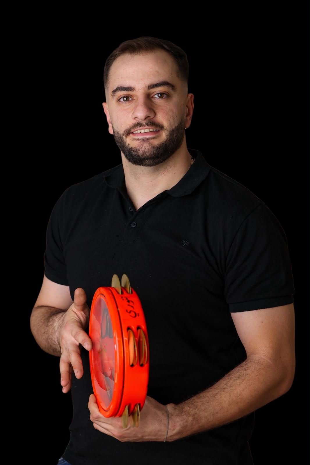 Tannoury Percussion craftsman holding a handmade orange riq