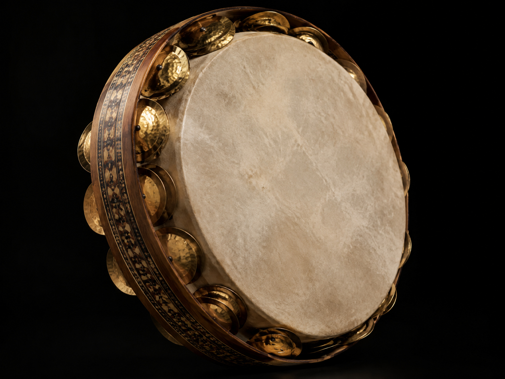 Mazhar frame drum with brass jingles on a black background